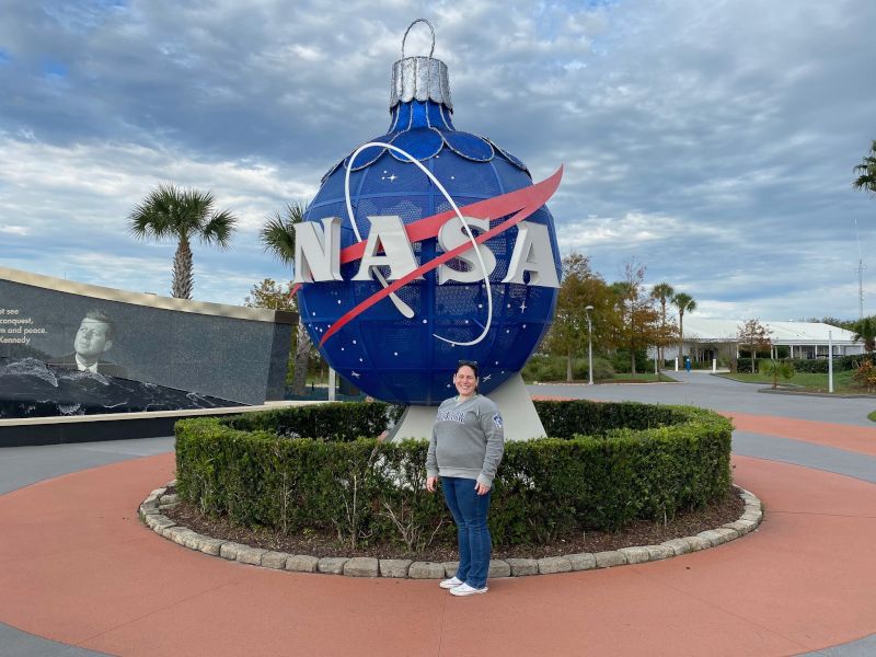 Alisha Posing in Front of the Giant NASA Ornament