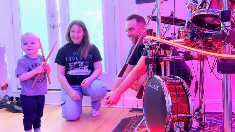 James Showing His Drumkit to a Friend's Child